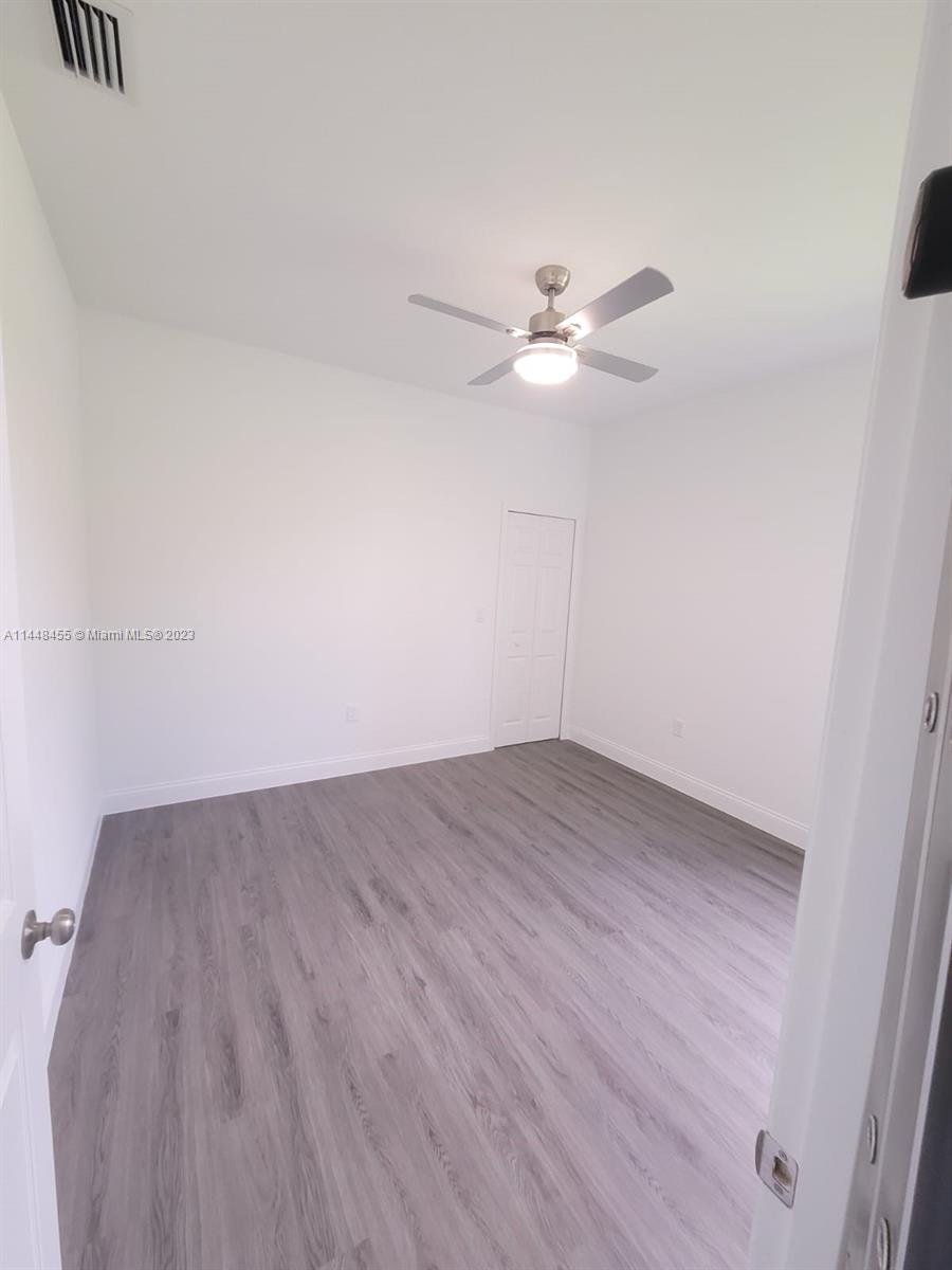 401 West 5th Street, Unit ST Lehigh Acres, FL 33972 - Photo 7 of 10 wooden floor in an empty room