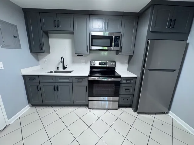 a kitchen with stainless steel appliances a stove a sink and a refrigerator