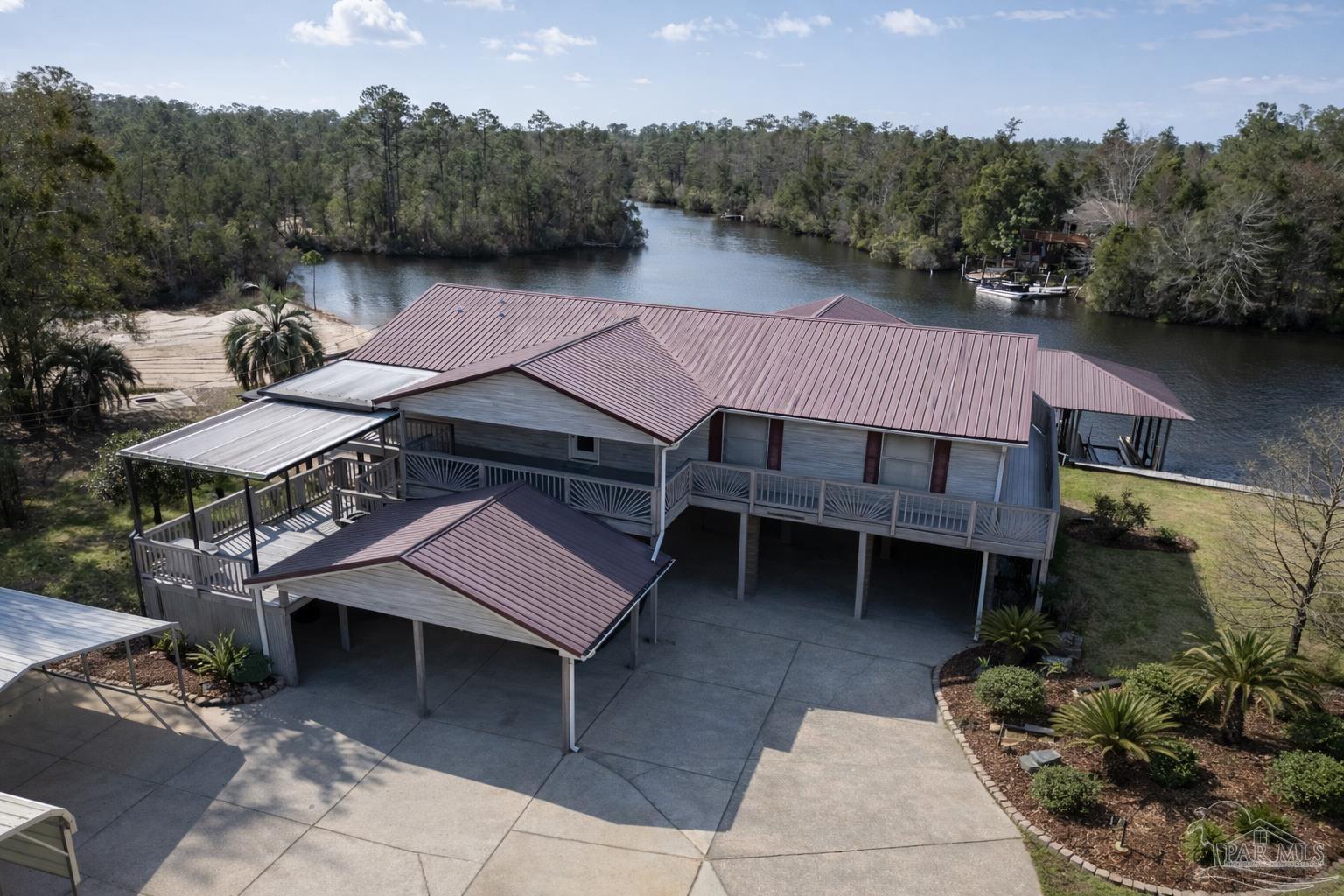 7608 River Road Milton, FL 32583 - Photo 1 of 28 a view of a patio with table and chairs with wooden floor and fence