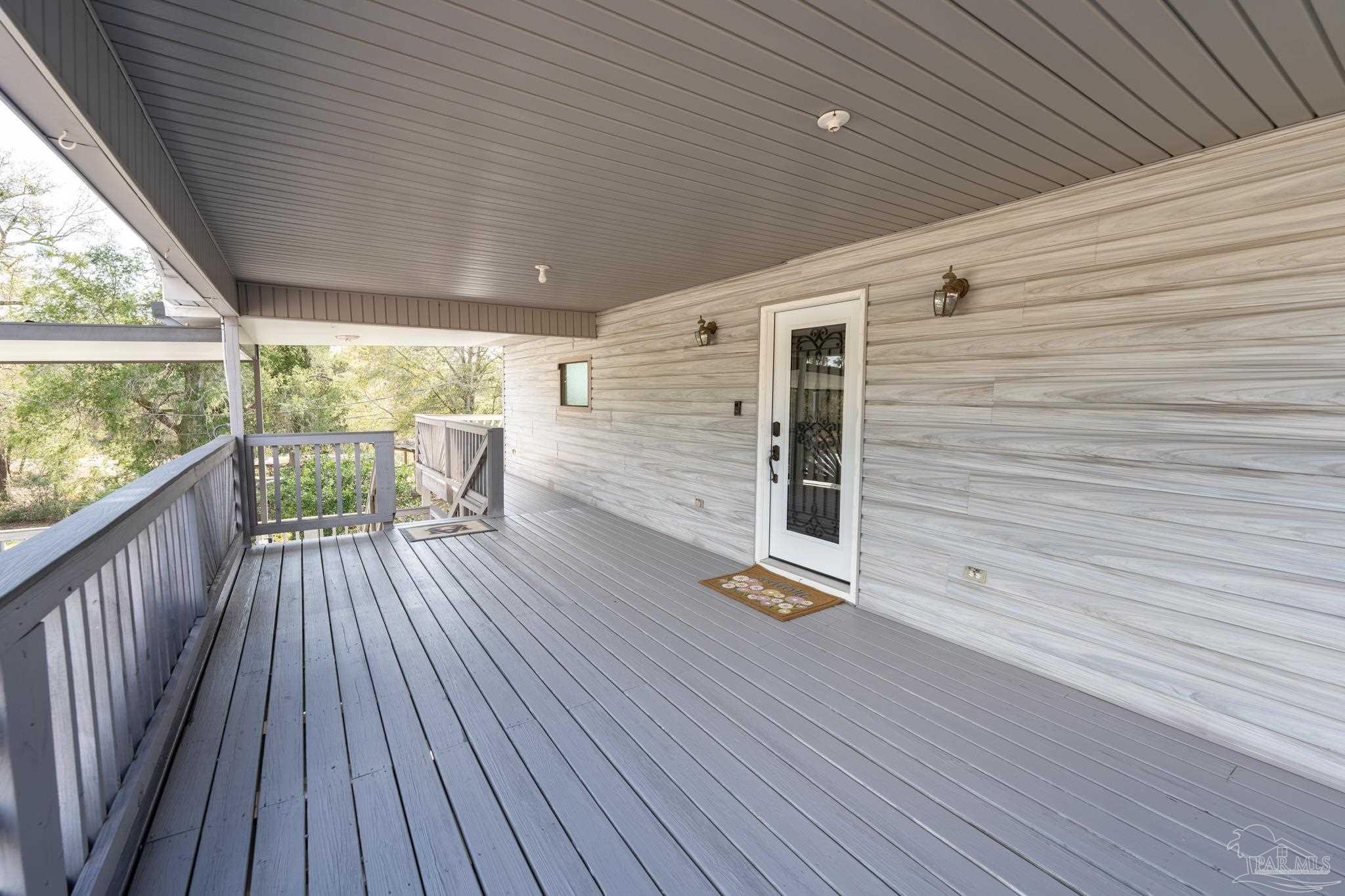 7608 River Road Milton, FL 32583 - Photo 12 of 28 a view of outdoor space with wooden floor and city view