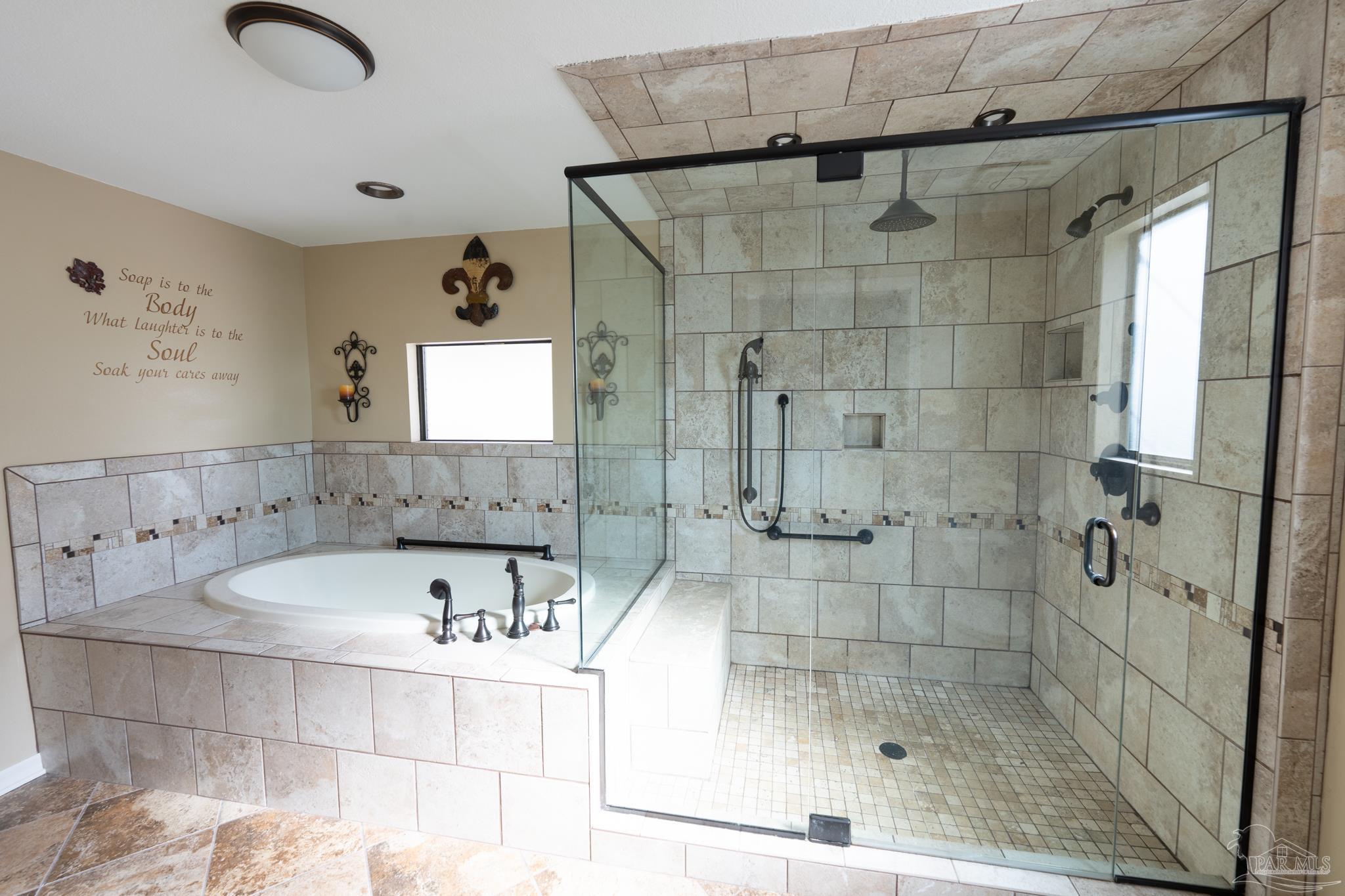 7608 River Road Milton, FL 32583 - Photo 15 of 28 a bathroom with a bathtub and shower