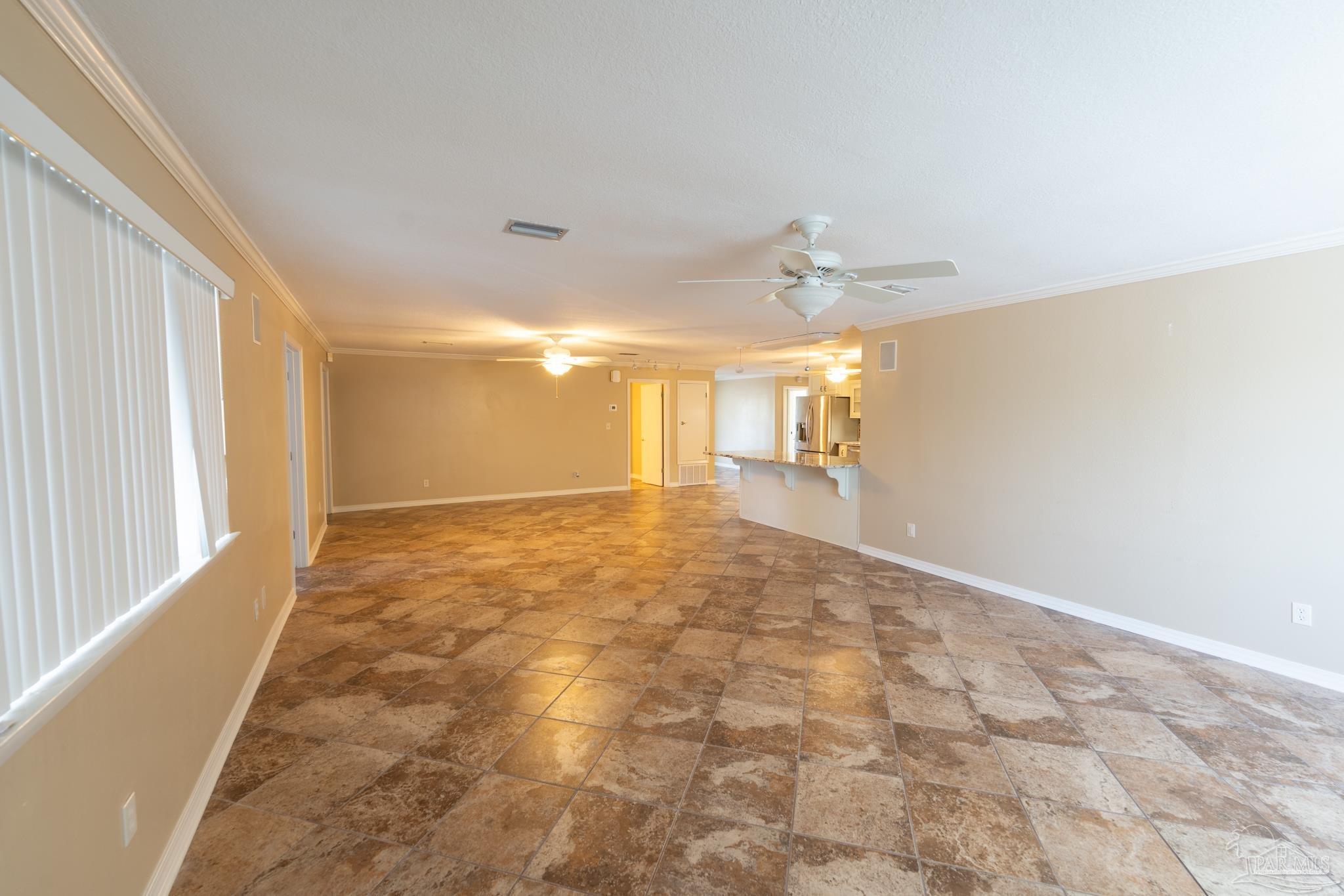 7608 River Road Milton, FL 32583 - Photo 21 of 28 a view of a big room with windows and chandelier fan
