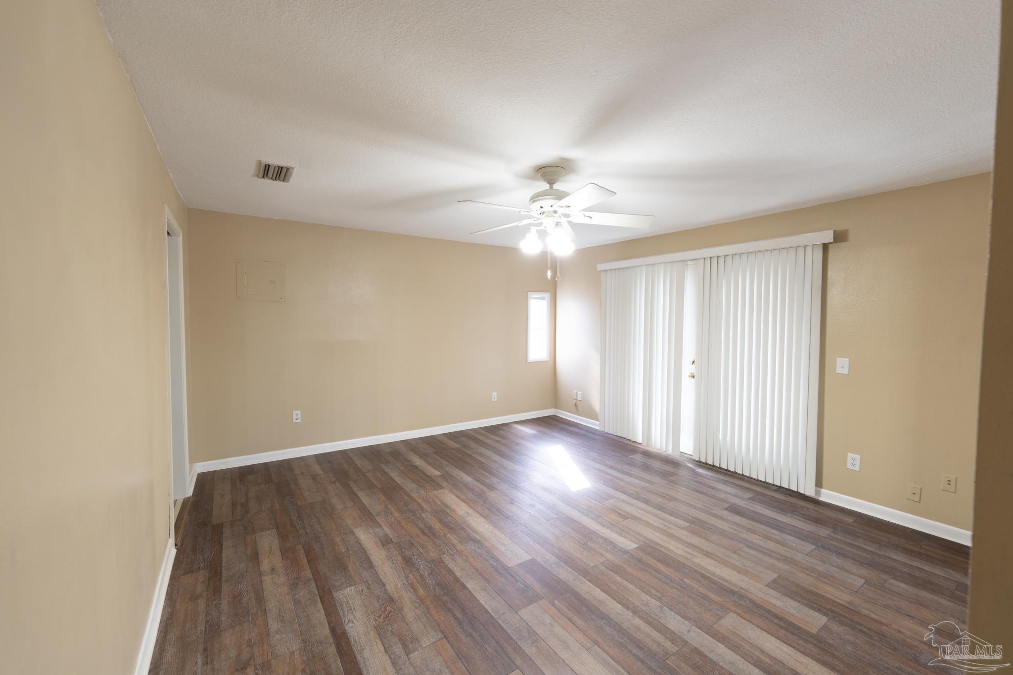 7608 River Road Milton, FL 32583 - Photo 22 of 28 a view of an empty room with wooden floor