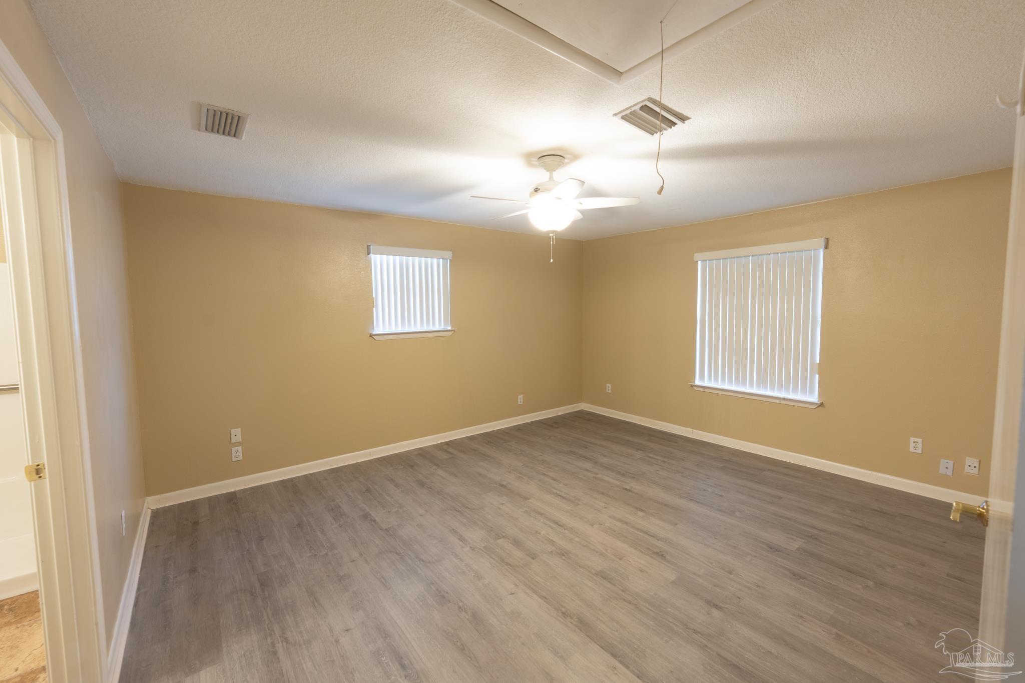 7608 River Road Milton, FL 32583 - Photo 24 of 28 wooden floor in an empty room with a window