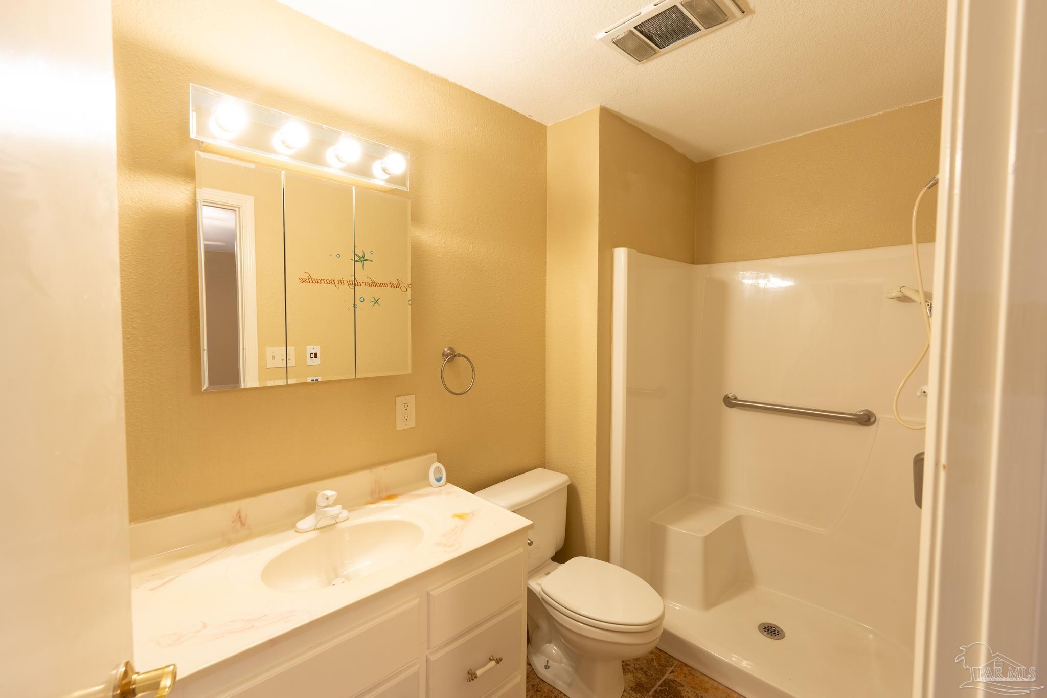 7608 River Road Milton, FL 32583 - Photo 25 of 28 a bathroom with a sink a toilet and shower