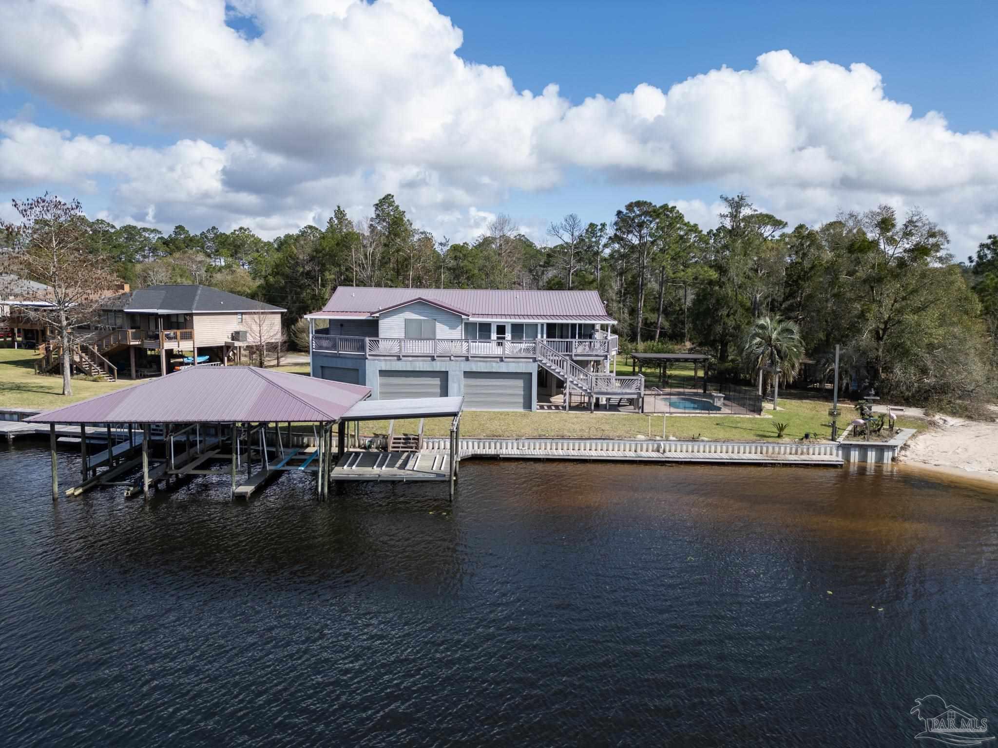 7608 River Road Milton, FL 32583 - Photo 4 of 28 a view of pool with lawn chairs and wooden fence