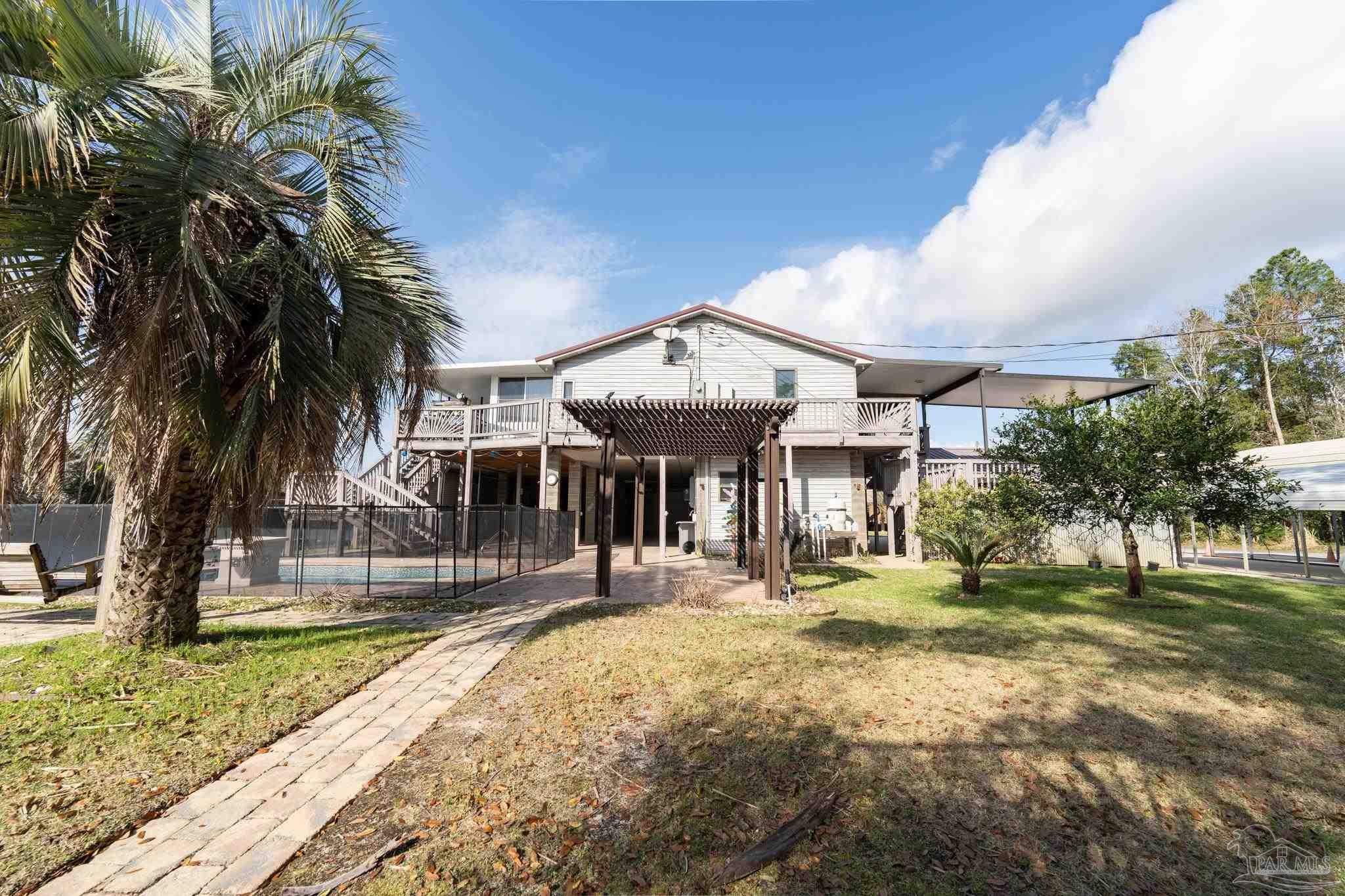 7608 River Road Milton, FL 32583 - Photo 5 of 28 a front view of a house with a yard