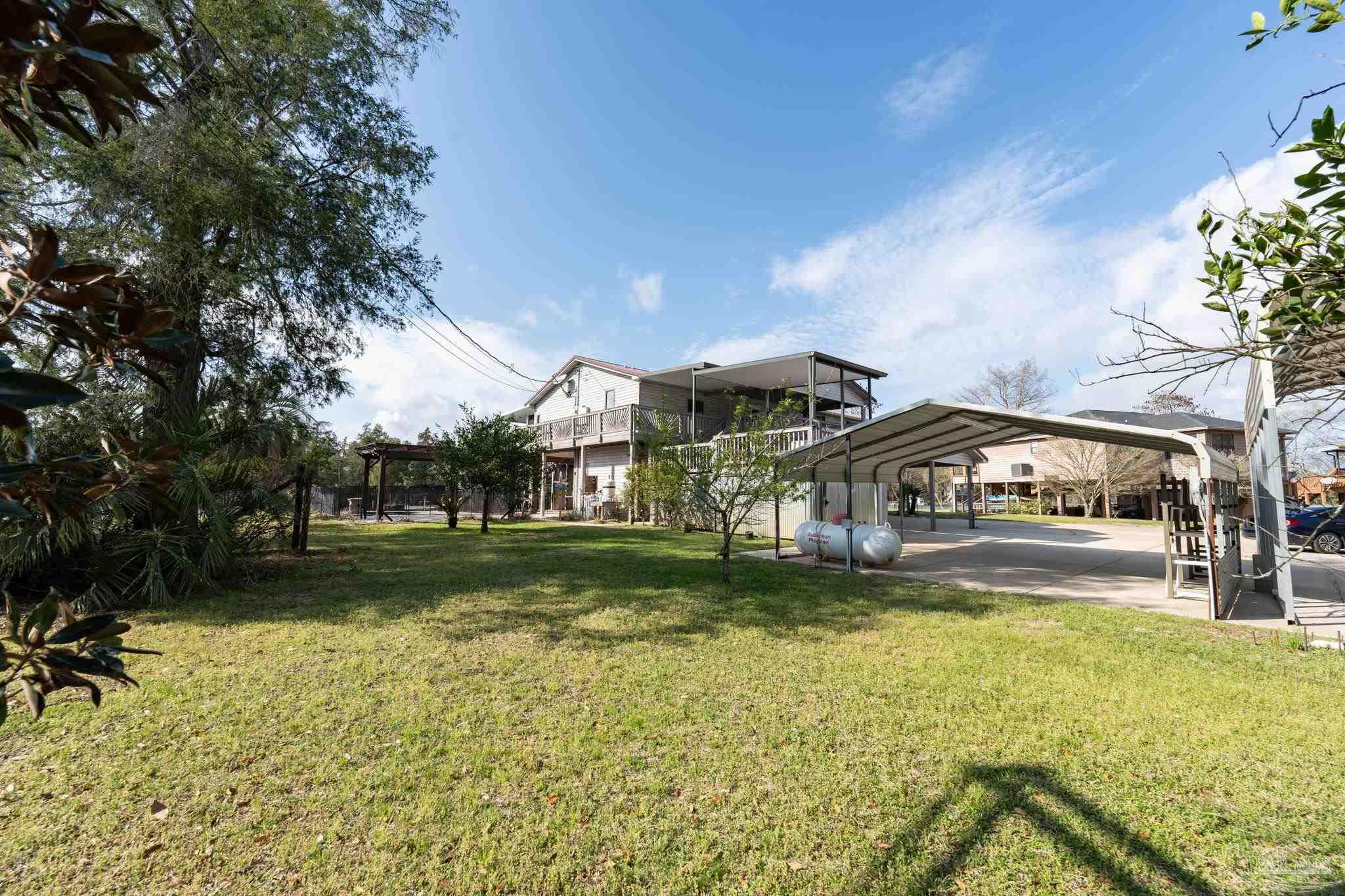 7608 River Road Milton, FL 32583 - Photo 6 of 28 a front view of a house with garden