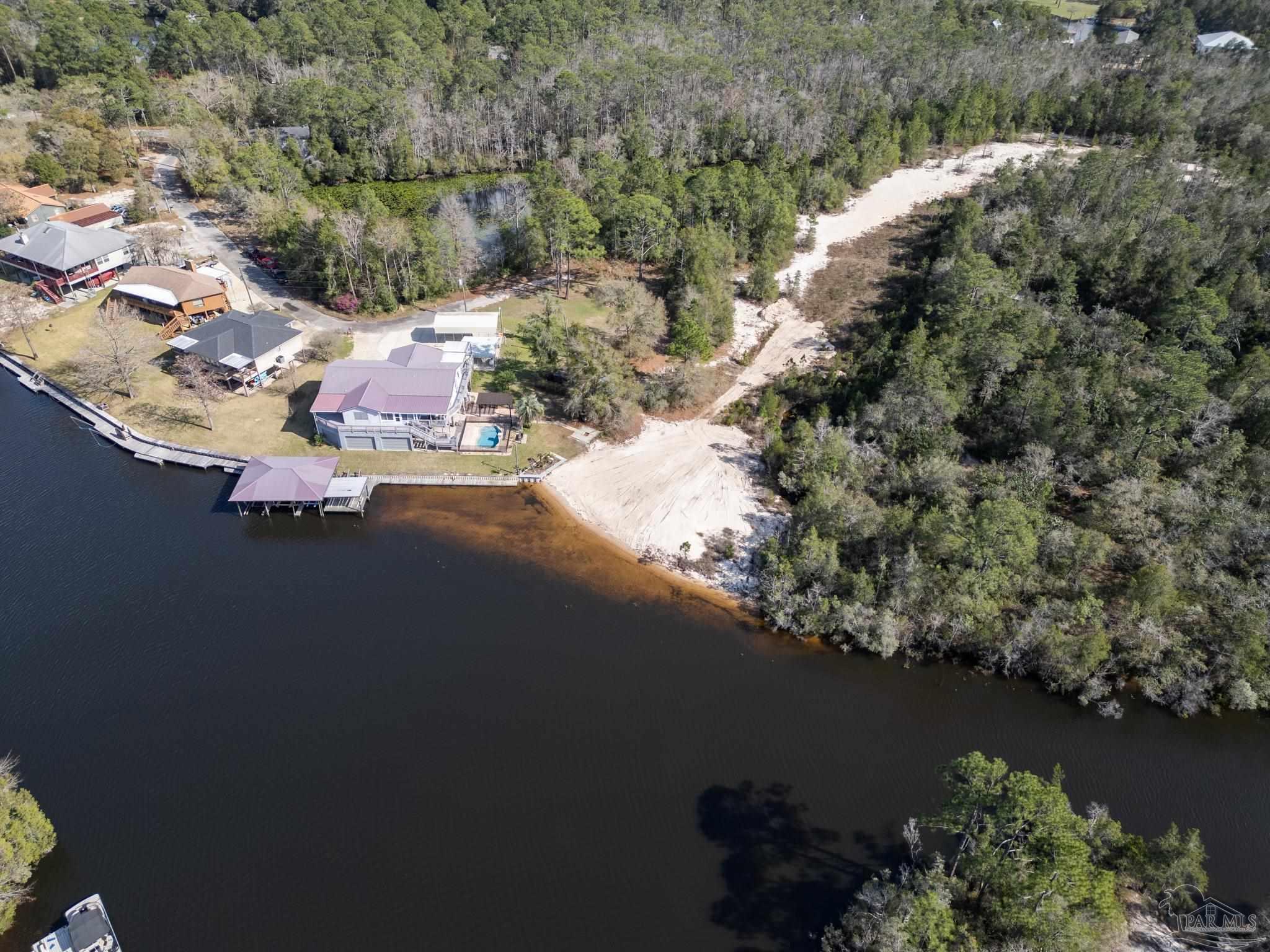 7608 River Road Milton, FL 32583 - Photo 8 of 28 an aerial view of a house with a yard and lake view