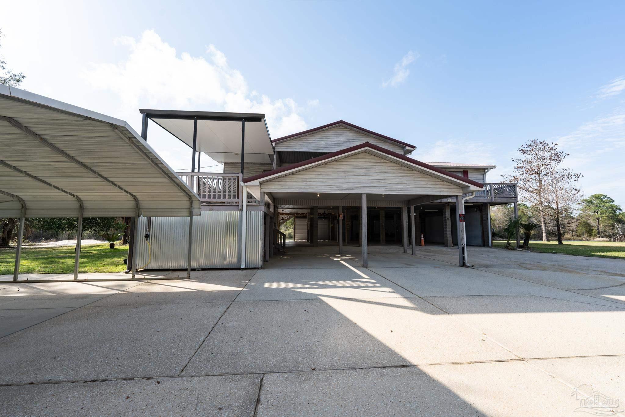 7608 River Road Milton, FL 32583 - Photo 9 of 28 a view of a house outdoor space and porch