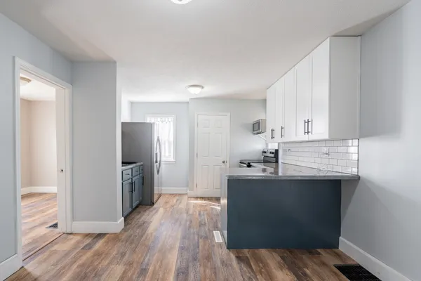 a kitchen with stainless steel appliances a sink stove and refrigerator