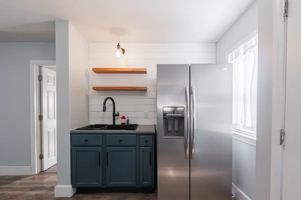 a kitchen with a refrigerator and a sink
