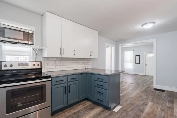 a kitchen with granite countertop a stove and a sink