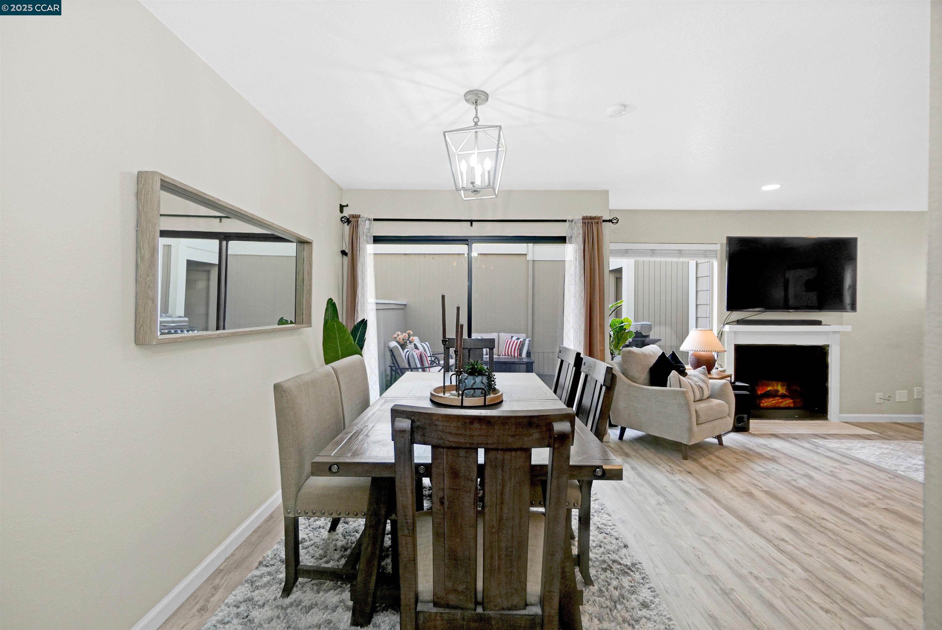 303 Atlas Drive, Unit 7 Hercules, CA 94547 - Photo 16 of 52 a view of a dining room with furniture a chandelier and wooden floor