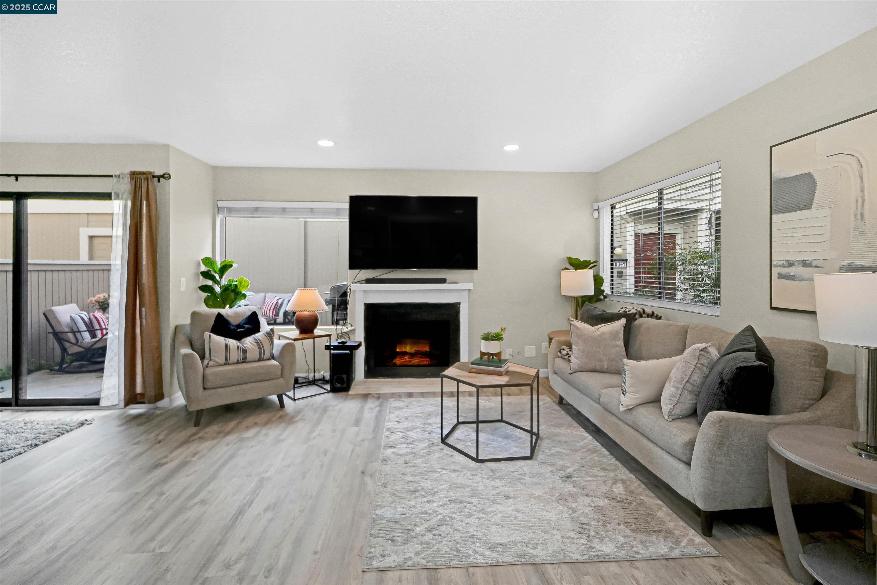 303 Atlas Drive, Unit 7 Hercules, CA 94547 - Photo 9 of 52 a living room with furniture a fireplace and a flat screen tv