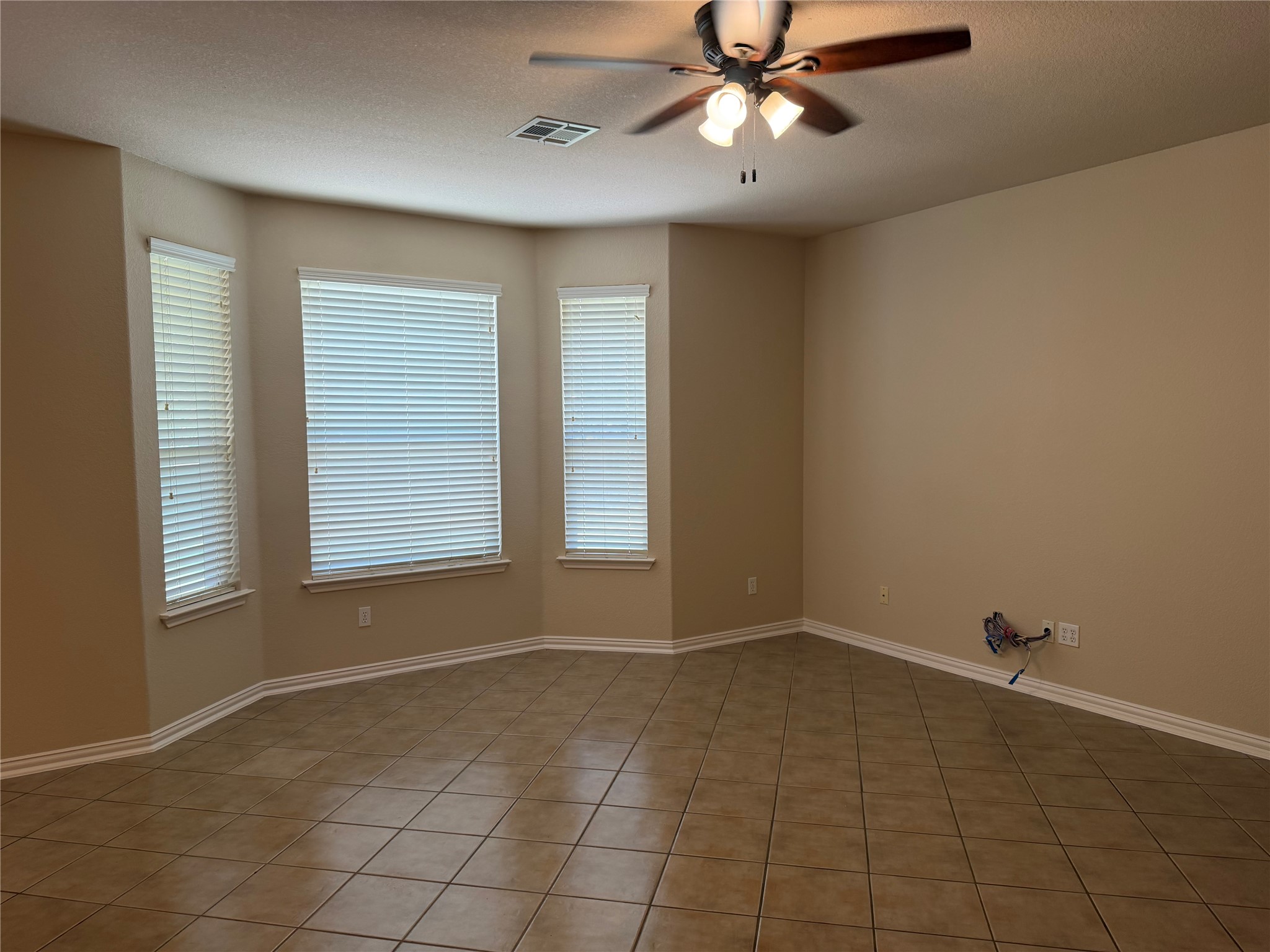 3021 Grand Mission Way Pflugerville, TX 78660 - Photo 8 of 31 A versatile living space with ceramic tile flooring and cooling ceiling fan awaits your personal touch.