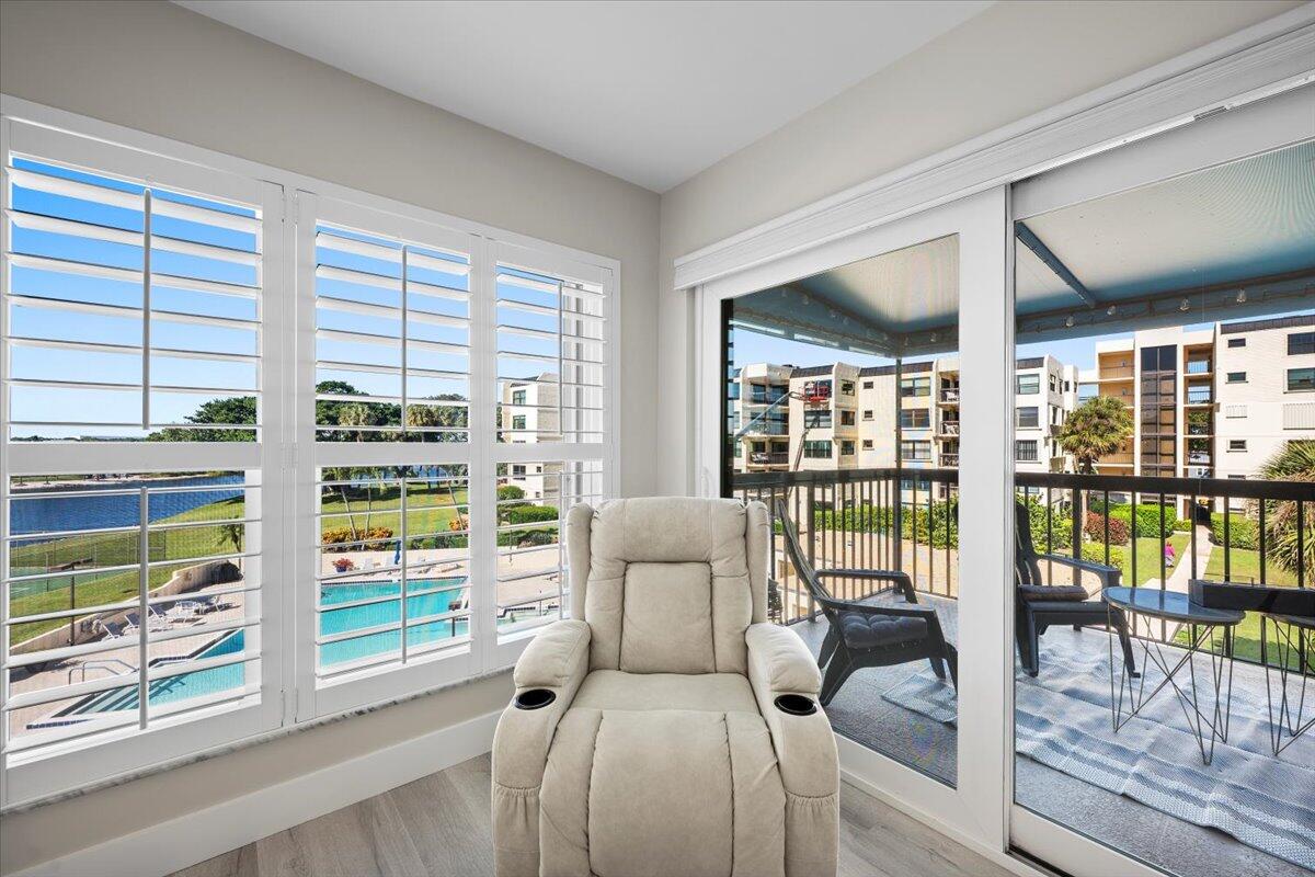 364 Golfview Road, Unit 405 North Palm Beach, FL 33408 - Photo 12 of 33 a living room with furniture and a floor to ceiling window