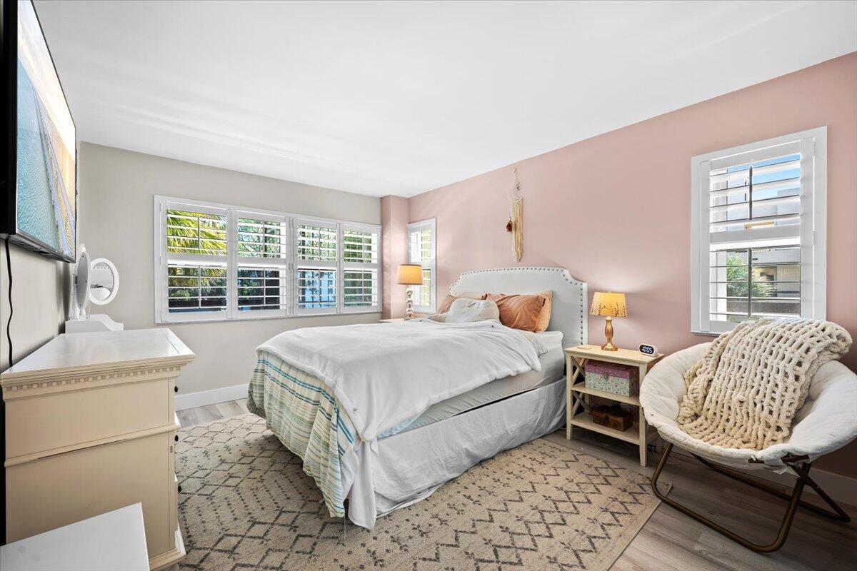 364 Golfview Road, Unit 405 North Palm Beach, FL 33408 - Photo 15 of 33 a bedroom with a bed dresser and a window