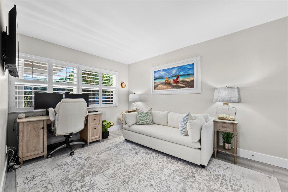 364 Golfview Road, Unit 405 North Palm Beach, FL 33408 - Photo 18 of 33 a living room with furniture a fireplace and a flat screen tv
