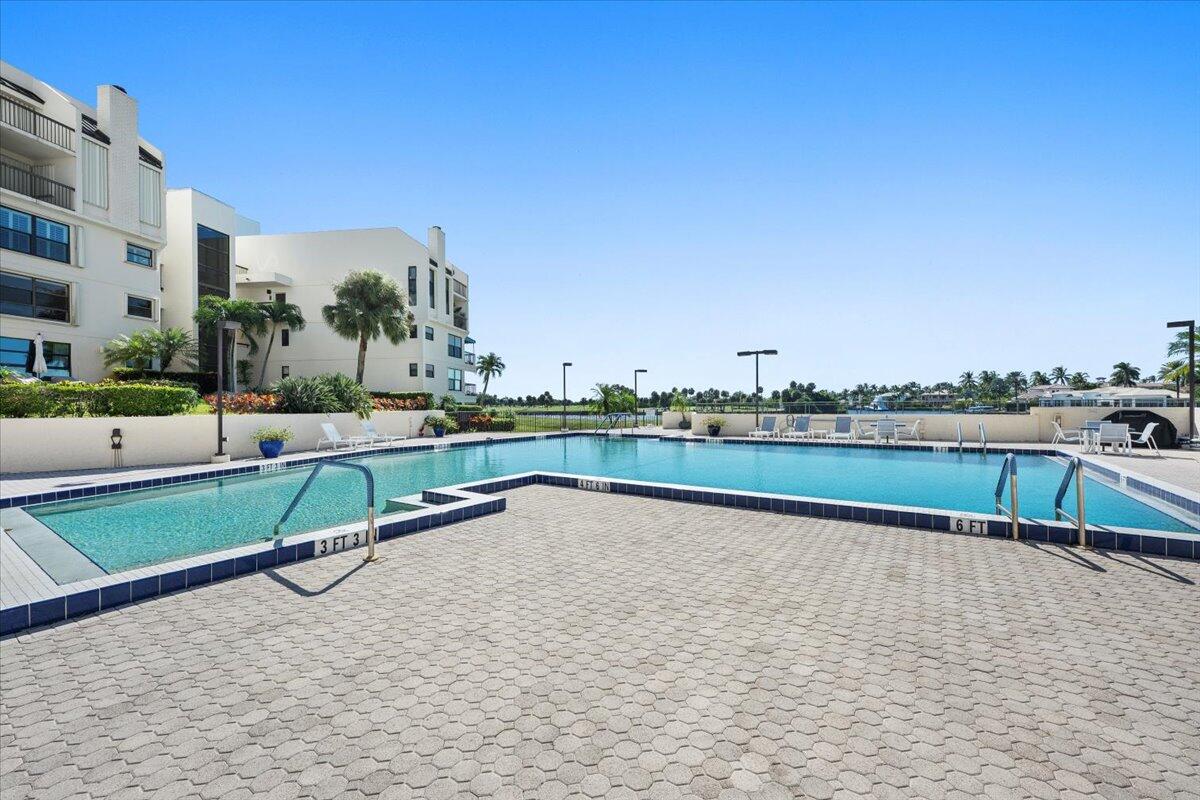 364 Golfview Road, Unit 405 North Palm Beach, FL 33408 - Photo 24 of 33 a view of swimming pool with outdoor seating and city view
