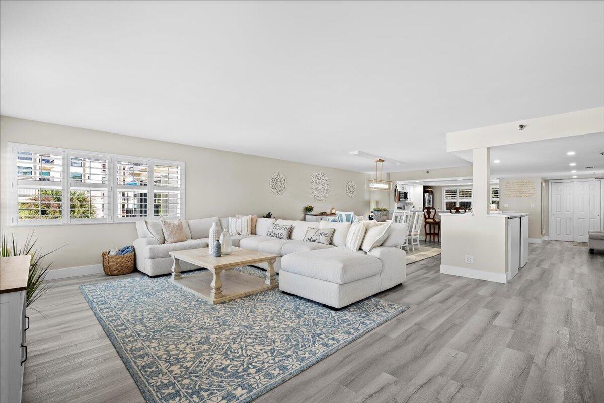 364 Golfview Road, Unit 405 North Palm Beach, FL 33408 - Photo 3 of 33 a living room with furniture and a large window with kitchen view