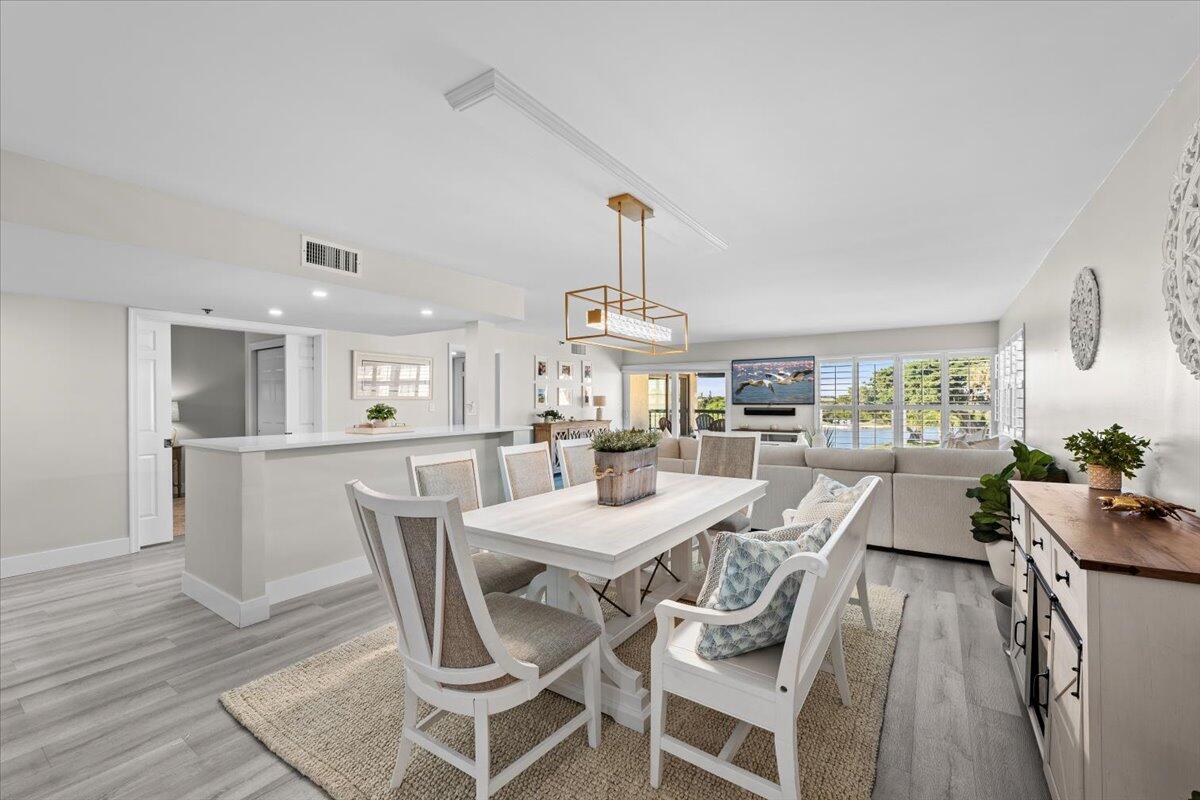 364 Golfview Road, Unit 405 North Palm Beach, FL 33408 - Photo 5 of 33 a view of a dining room with furniture and wooden floor
