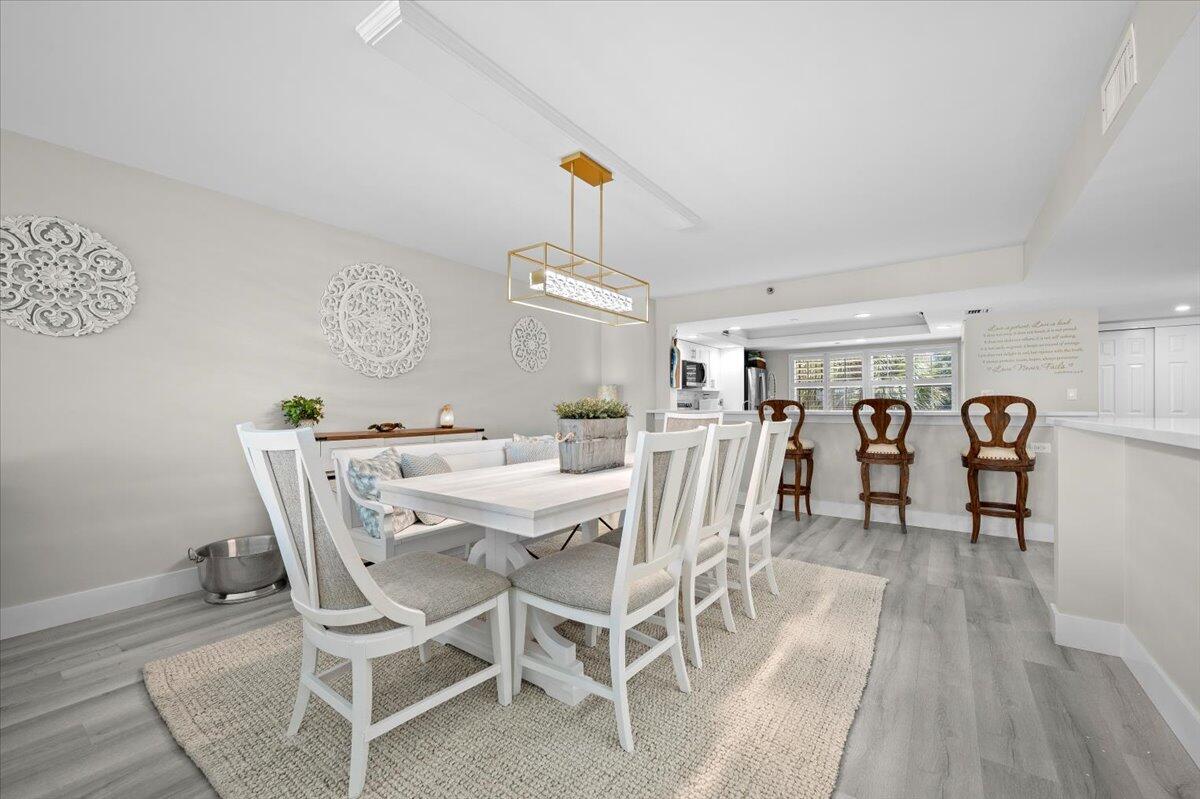 364 Golfview Road, Unit 405 North Palm Beach, FL 33408 - Photo 6 of 33 a dining room with furniture and wooden floor