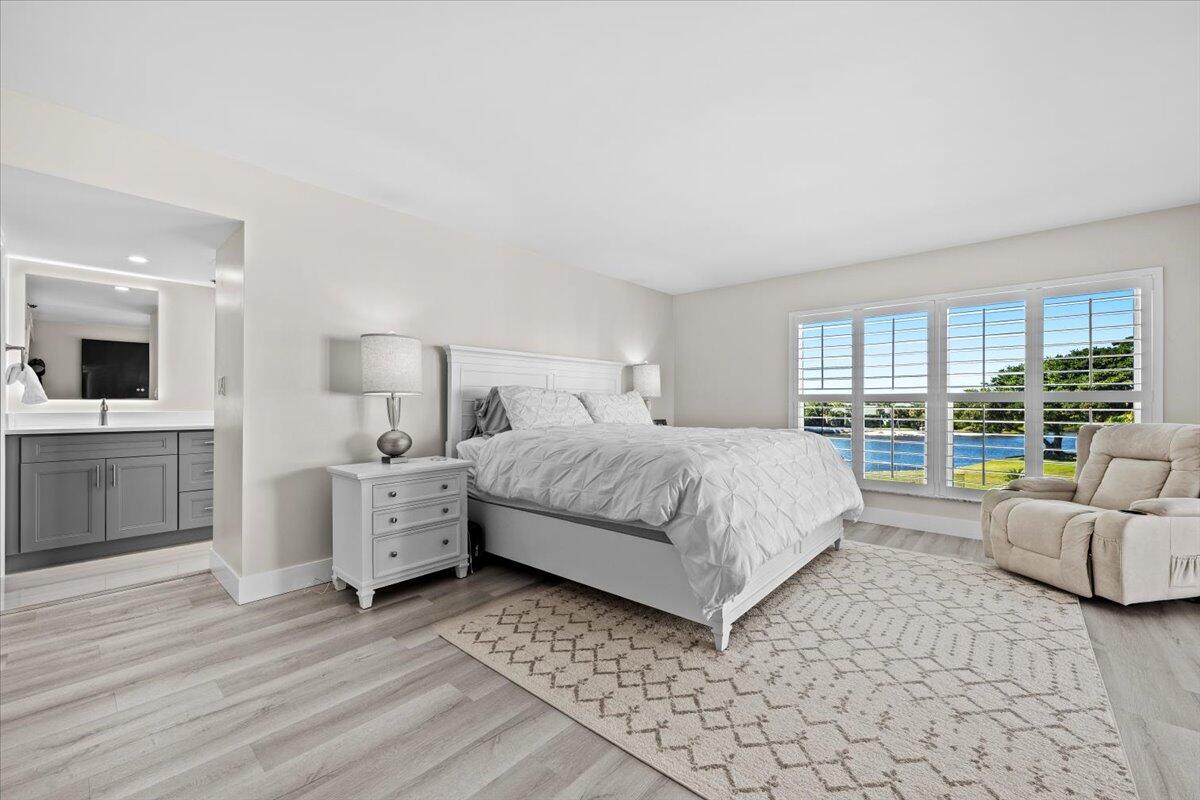 364 Golfview Road, Unit 405 North Palm Beach, FL 33408 - Photo 10 of 33 a bedroom with a large bed and a view of living room