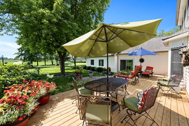 a view of a house with a big yard and large trees