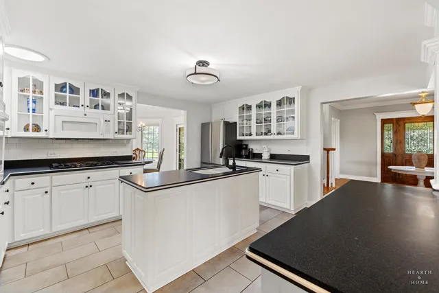 a dining room with furniture a chandelier and wooden floor
