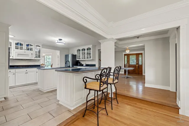 a view of a dining room with furniture a chandelier and wooden floor