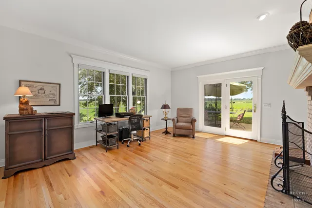 a view of a hallway with wooden floor and windows