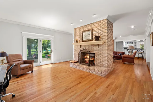 a view of a hallway with wooden floor and stairs