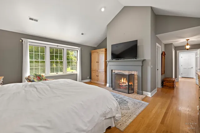 a spacious bathroom with a granite countertop sink a toilet a mirror and a window