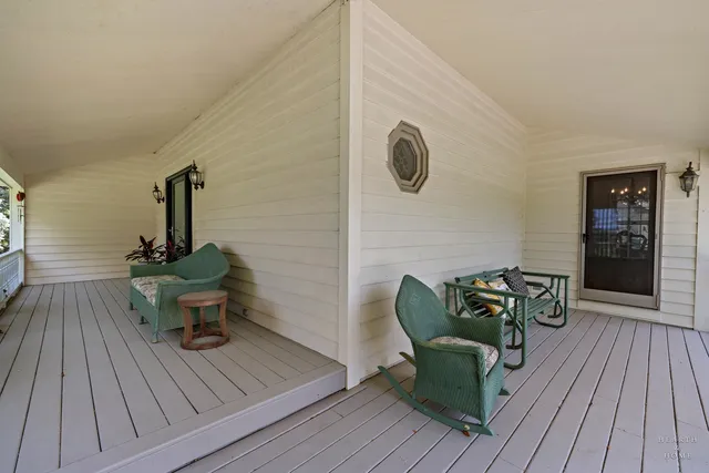 a view of a livingroom with wooden floor and a chandelier