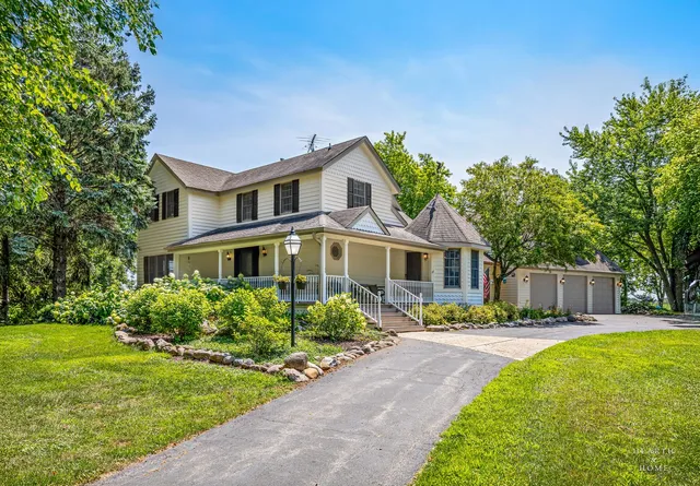 an aerial view of ocean with residential house outdoor space and swimming pool