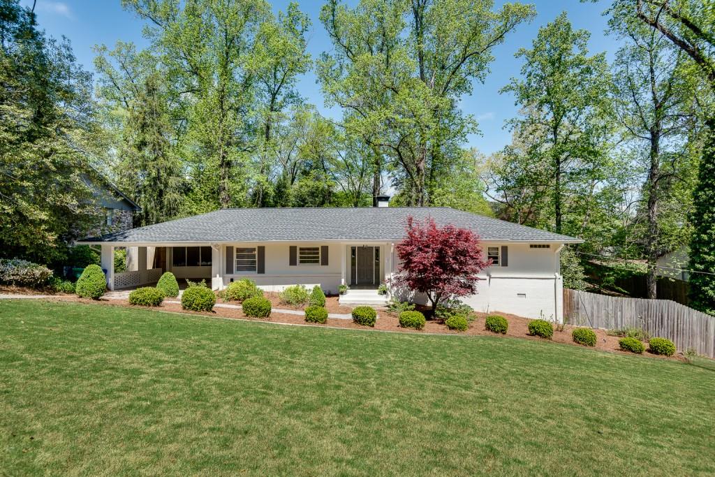 a front view of house with yard and trees
