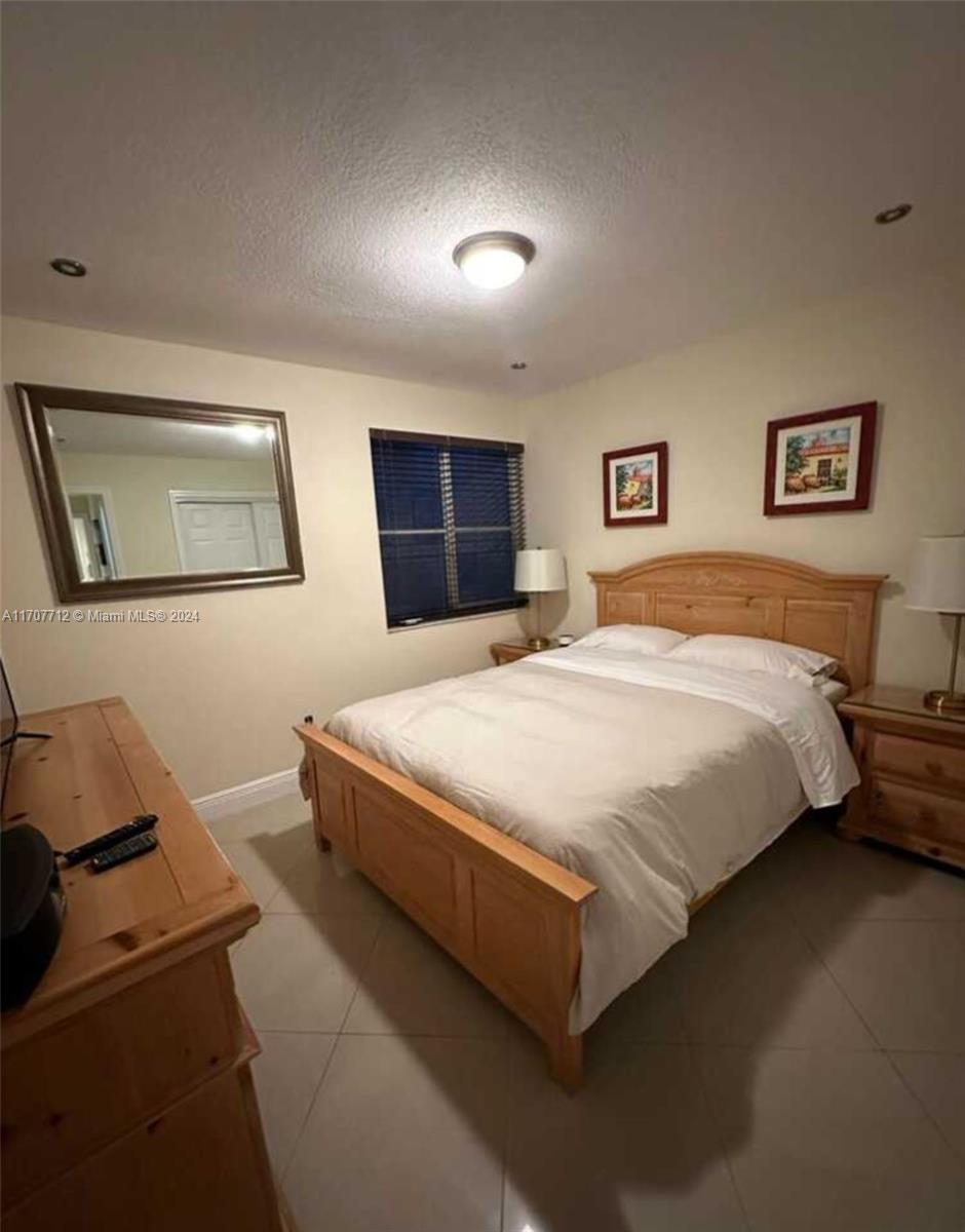 The Hammocks Miami, FL 33196 - Photo 2 of 6 a bedroom with a bed and night stand