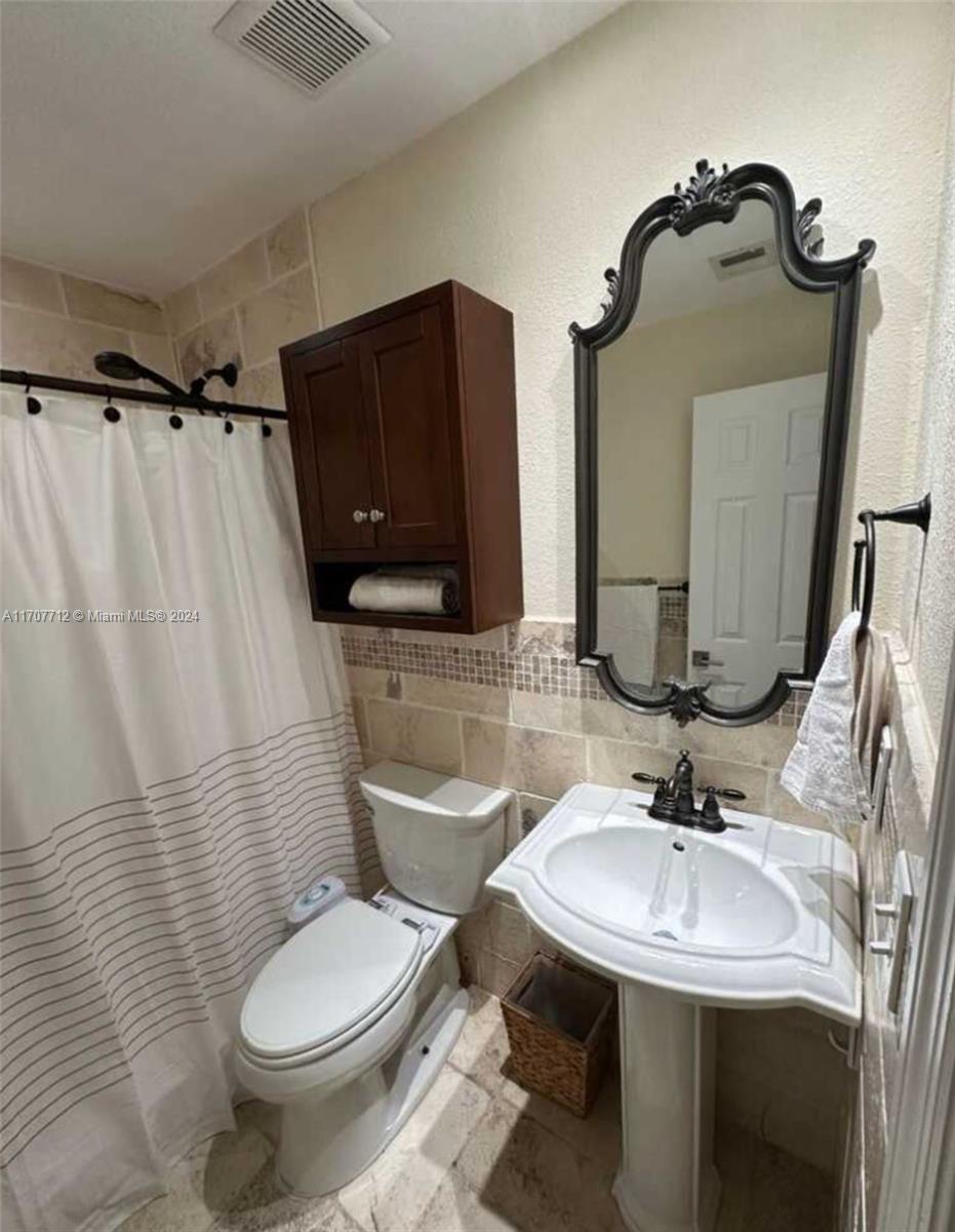 The Hammocks Miami, FL 33196 - Photo 3 of 6 a bathroom with a sink toilet and mirror