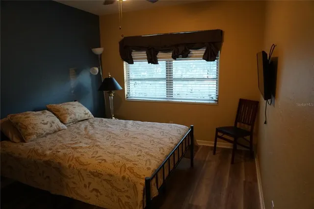 a bedroom with a bed and a window