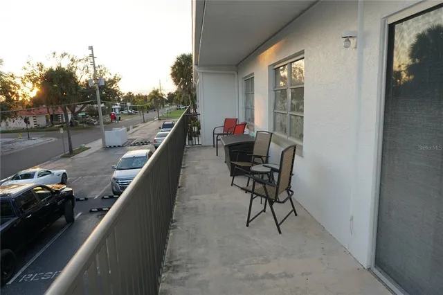 a view of a chairs and tables in the balcony