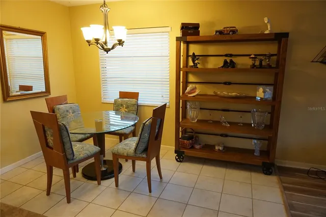 a view of a dining room with furniture and a chandelier