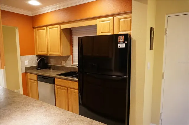 a kitchen with a refrigerator and cabinets