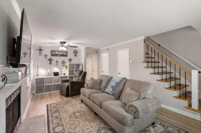 a living room with furniture flat screen tv and a fireplace