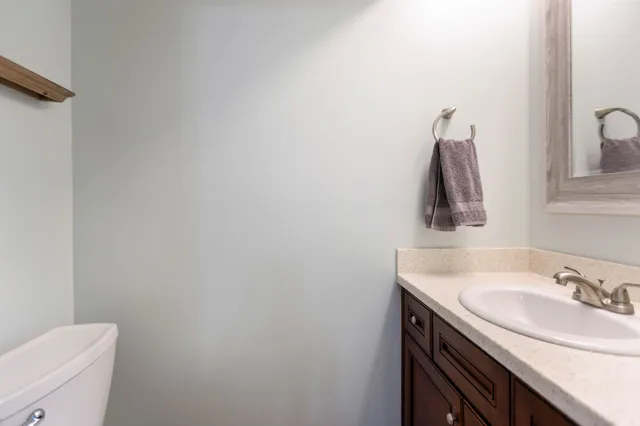 a bathroom with a sink toilet and mirror