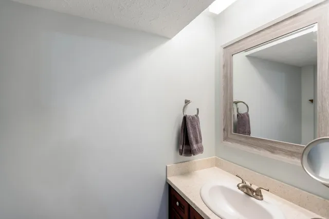 a bathroom with a sink and a mirror