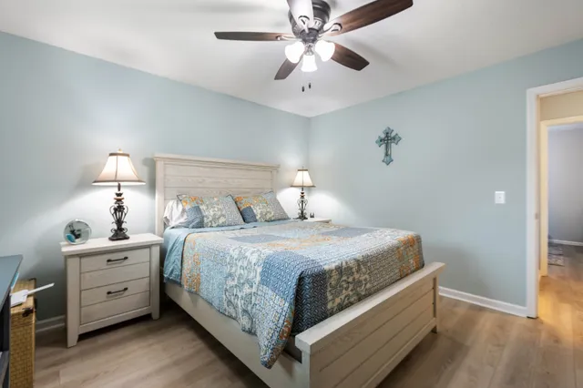 a bedroom with bed and a chandelier