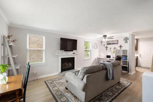 a living room with furniture a flat screen tv and a fireplace
