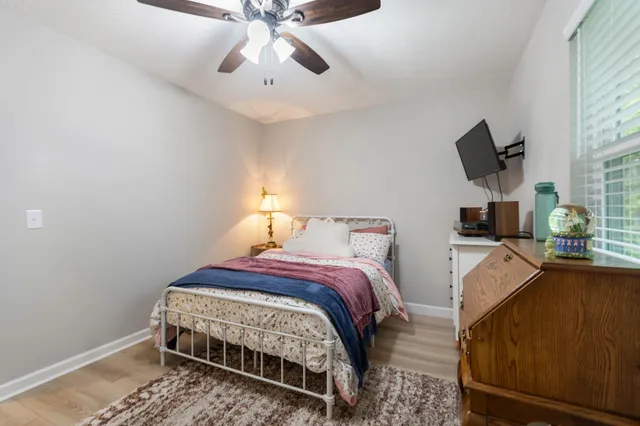 a bedroom with a bed and flat screen tv