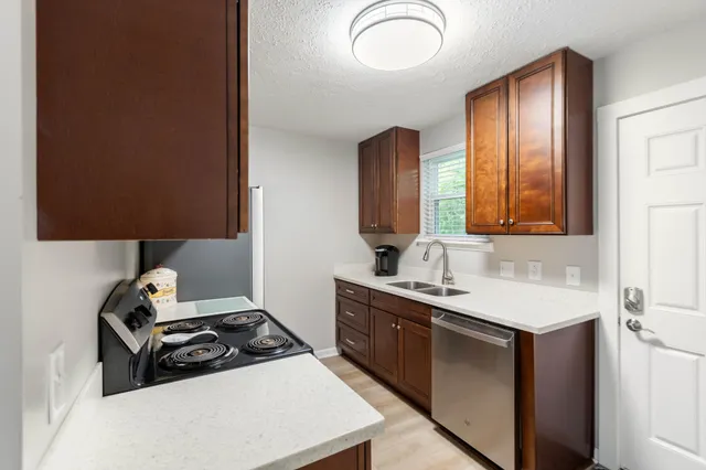 a kitchen with a sink stove and cabinets